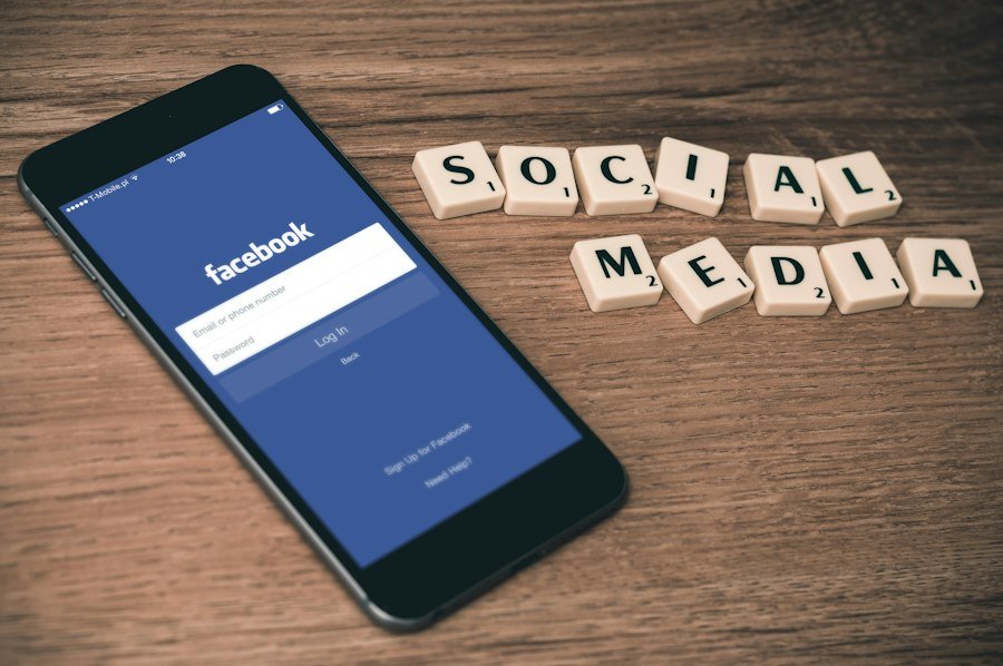 Phone beside social media lettering
